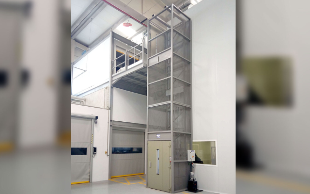 Elevador simple en instalación industrial con estructura metálica visible