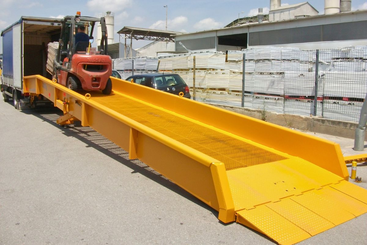 Rampa de carga móvil conectada a camión en operación de descarga
